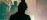 Interior silhouette of practitioner below a skylight