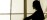 Practitioner silhouette behind gauze curtains in soft light