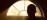 Interior silhouette of practitioner beside warm fireplace glow during reflection