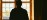 A practitioner's silhouette framed within an architectural arch, soft interior light creating depth