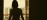 Practitioner silhouette in warm candlelit interior space